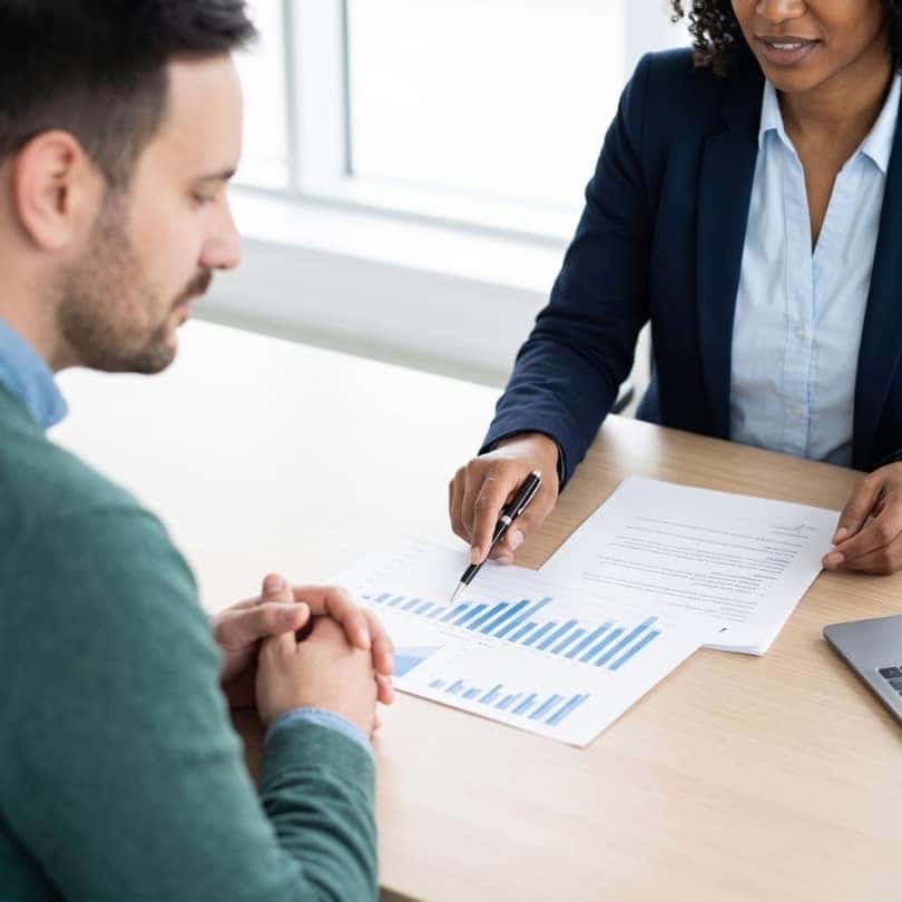 Customer looking over financial documents with a consultant.