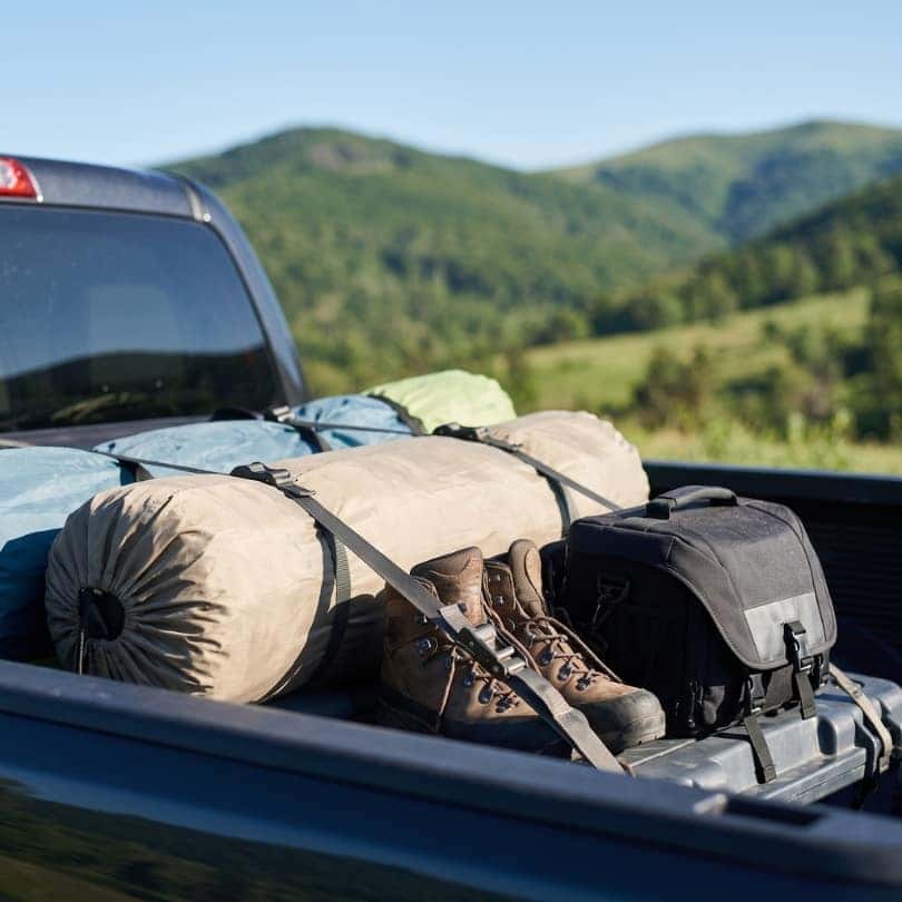 Camping equipment is securely fastened within a truck bed.