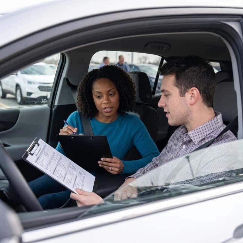 Couple reviewing a vehicle history report.