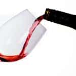 Red wine being poured into a glass.