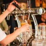 Bartender pouring a beer from the tap.