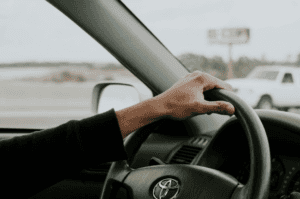 interior view of someone driving a Toyota down the road