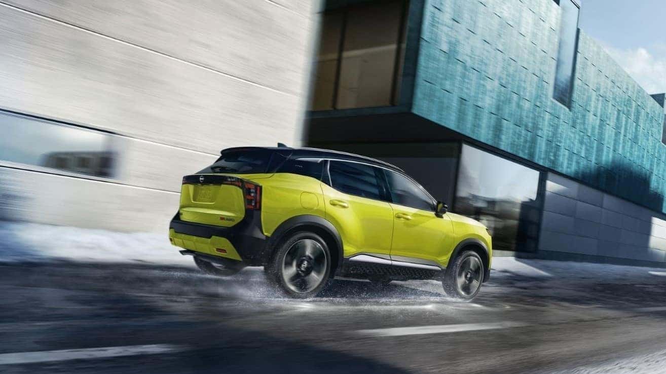 Yellow 2026 Nissan Kicks driving in the snow.