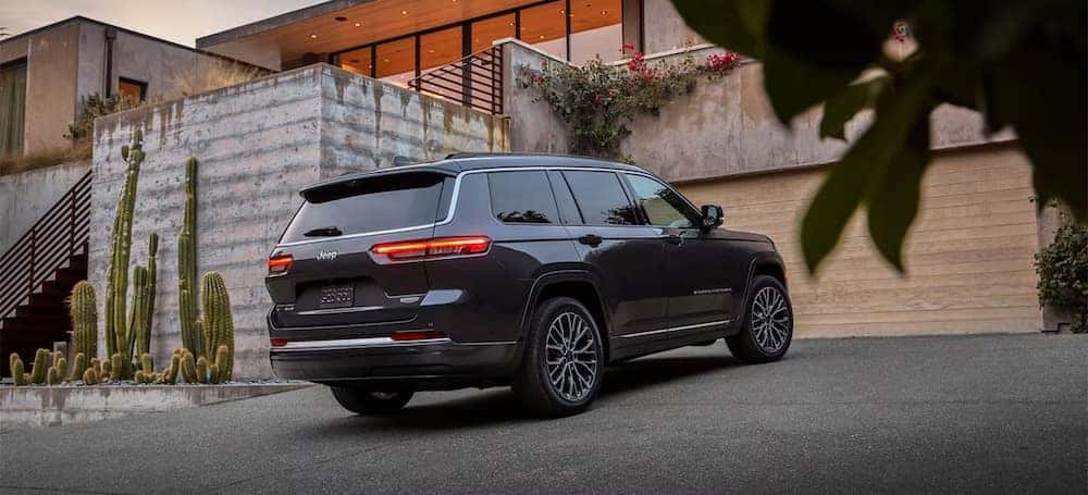 A black 2026 Jeep Grand Cherokee SUV parked in a driveway
