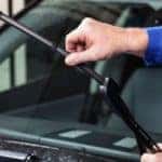 A man checking his vehicle's windshield wiper - El Dorado Chevrolet in McKinney, Texas