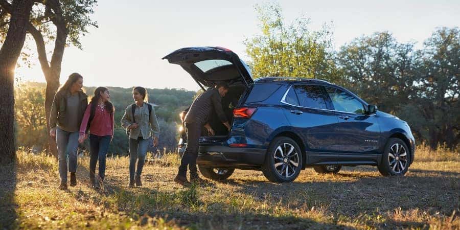 2022 Chevrolet Equinox A family next to a parked 2022 Chevrolet Equinox | El Dorado Chevrolet in McKinney, Texas