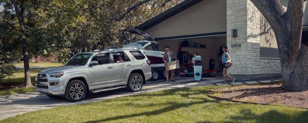 Dad loading trunk of silver Toyota 4Runner