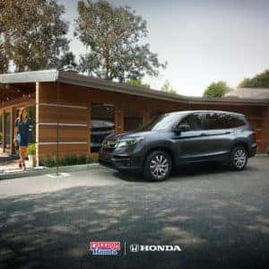 A woman walking towards a 2021 Honda Pilot