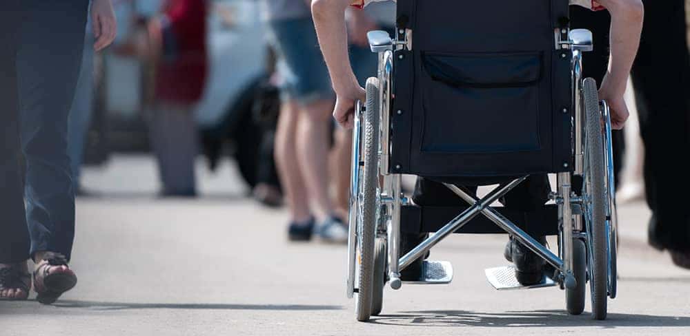 Behind someone in Wheel chair