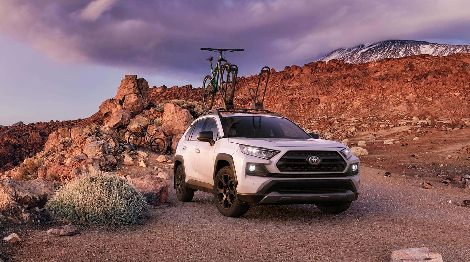 Performance features of the 2020 Toyota RAV4 at Glen Toyota | white 2020 RAV4 parked on mountain terrain