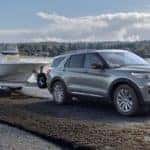 Silver 2020 Ford Explorer towing boat out of lake