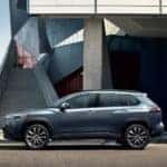A grey 2022 Toyota Cross is shown from the side leaving a Toyota dealer near you.
