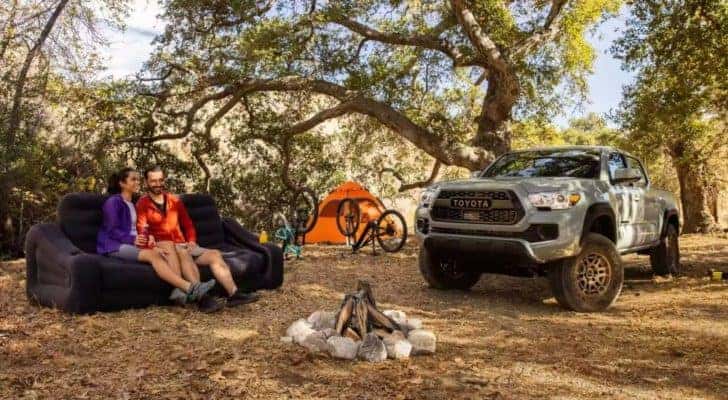 A grey 2023 Toyota Tacoma SR5 Trail Edition is shown at a campsite.
