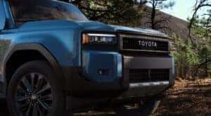 Close-up of the front end of a blue 2024 Toyota Land Cruiser for sale.