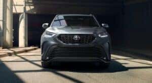 Front view of a grey 2021 Toyota Highlander parked on a driveway.