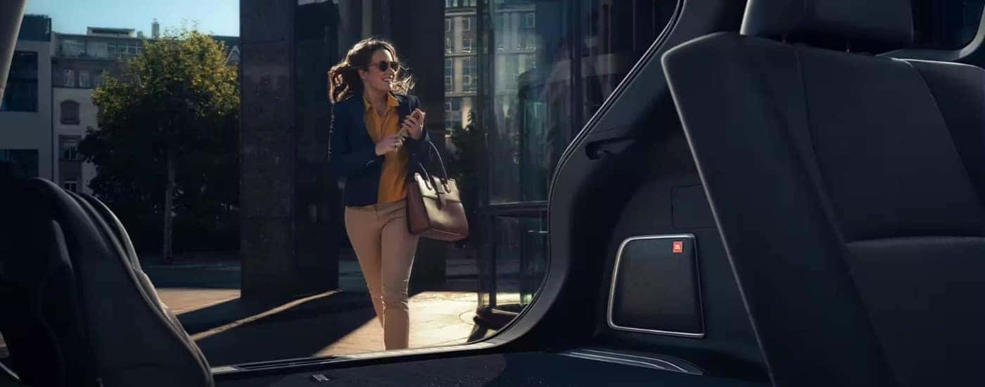 A person walking toward a 2023 Toyota Venza.