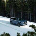 INFINITI driving on a snowy road