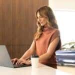 Woman sitting at a kitchen area in an INFINITI service center