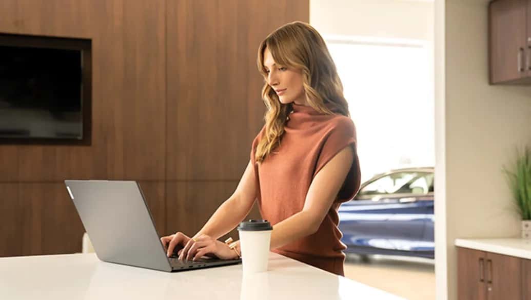 Woman sitting at a kitchen area in an INFINITI service center