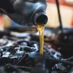 pouring oil into car