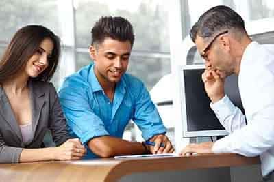 Young Couple Signs a Contract For the Purchase of a New Car