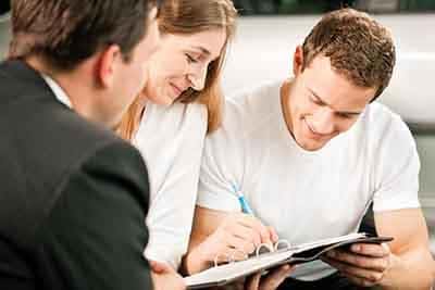 Couple signing finance papers