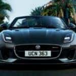 2020 F-TYPE R-Dynamic AWD in Silicon Silver driving on palm tree lined street