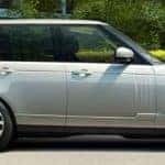 Land Rover Range Rover parked with a bunch of greenery background