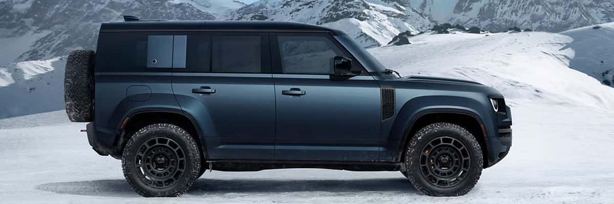 2025 Land Rover Defender SUV Sitting on a Snowy Hill