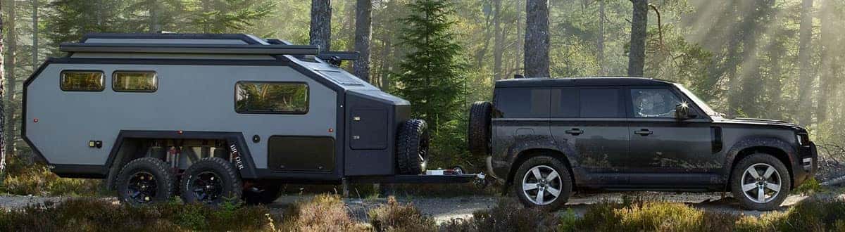 2026 Defender 110 Luxury SUV Towing a Camper