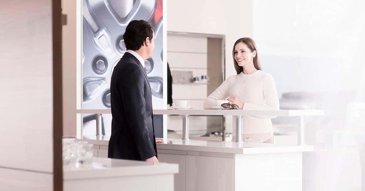 Land Rover Dealership - Sales rep with customer