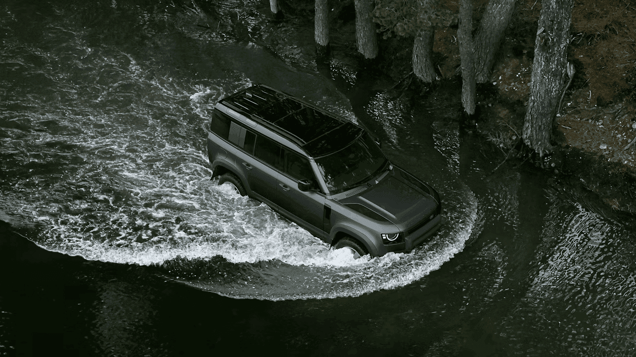 2026 Defender 110 showcasing its advanced off-road capability and terrain technology on a rugged trail