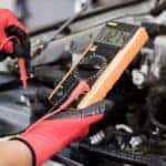 Range Rover service tech inspecting a battery