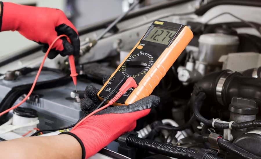 Range Rover service tech inspecting a battery