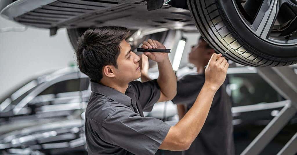 Land rover service tech checking tread depth