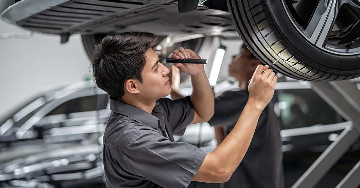 Land rover service tech checking tread depth