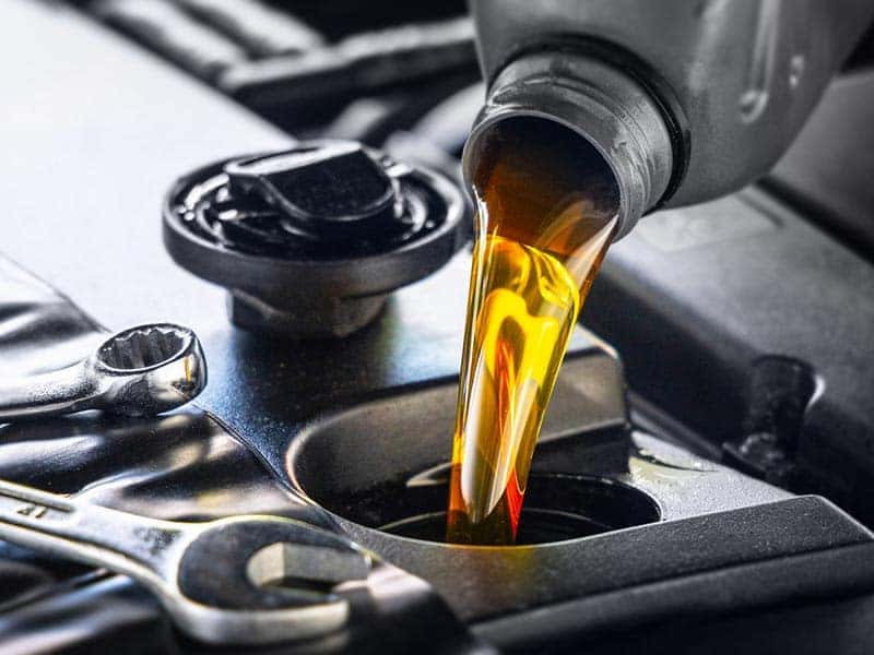 Oil Bottle Pouring in to an engine