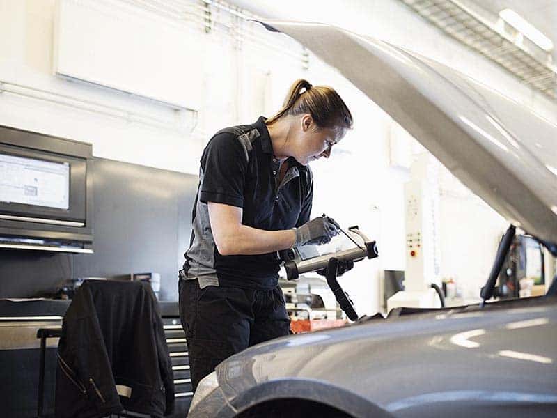 Service technician inspecting vehicle