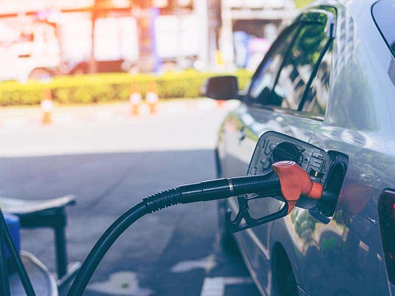 Car getting fuel at a gas station.