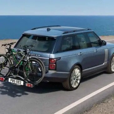 2018 Land Rover Range Rover driving with bikes on rack