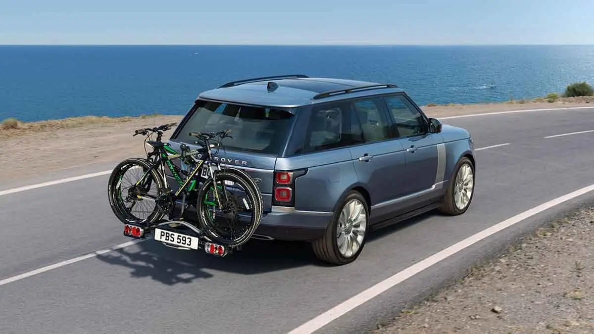 2018 Land Rover Range Rover driving with bikes on rack