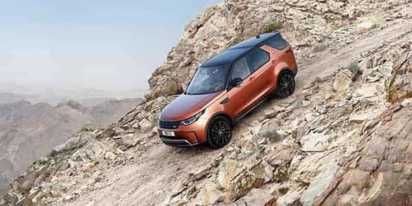 2018 Land Rover Discovery driving down gravel hill