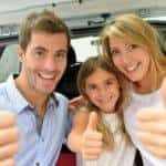 Cheerful smiling family showing thumbs up