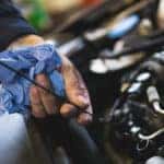 Mechanic checking oil level