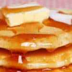 close up of pancakes covered in syrup
