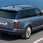 blue 2019 range rover driving on coastal highway