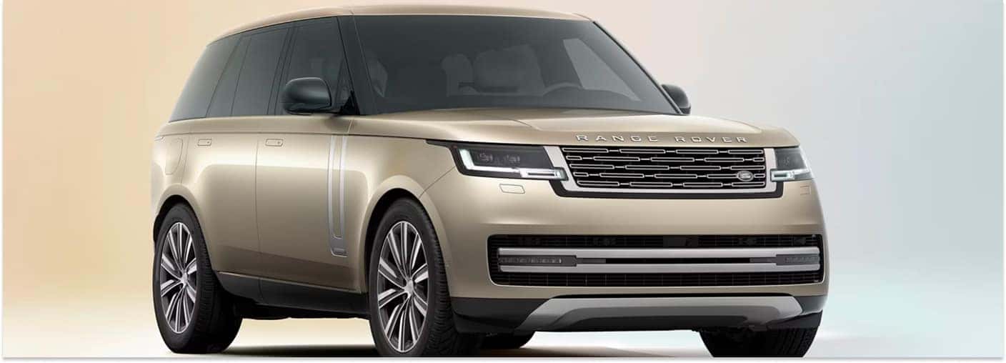 Front three-quarter view of a gold 2026 Land Rover Range Rover SUV in a studio backdrop.