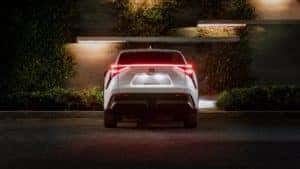 White Toyota RAV4 Prime XSE from behind with rear lights on at night