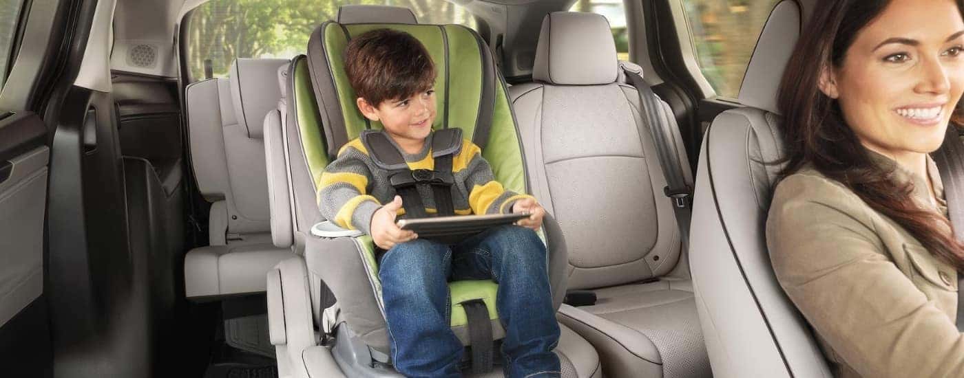 A child is shown using a tablet in a 2024 Honda Odyssey Elite.