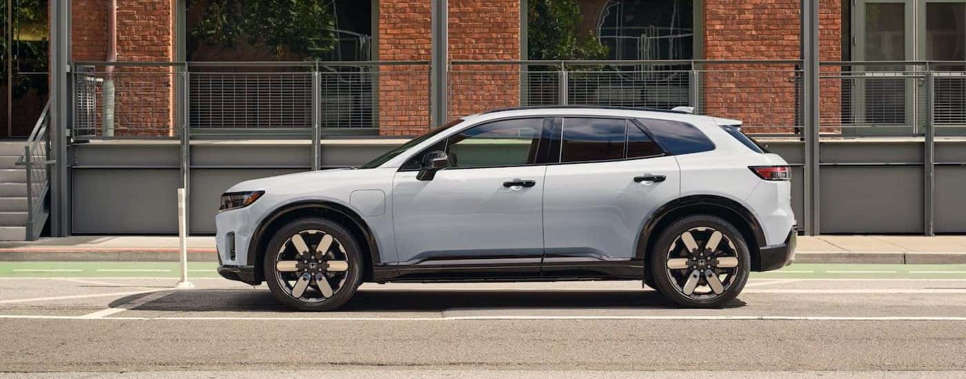 A white 2025 Honda Prologue is shown from the side after leaving a Honda dealer in Manchester.